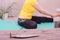 Yoga at home. Concept of online fitness classes. In the foreground is burning incense, in the background is the blurry silhouette