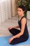 Yoga at home. Keep calm. Attractive young woman sitting on lotus position on floor