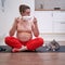 Yoga at home during pregnancy with a medical mask on your face. Pregnant woman on workout during lockdown due to coronavirus