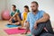 Yoga instructor guiding students in practicing Ardha Matsyendrasana