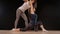 Yoga instructor helps student with stretching her shoulders. Happy sport fit girls