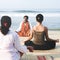 Yoga Instructor And His Students By The Beach Concept