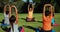 Yoga instructor instructing children in performing exercise