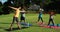 Yoga instructor instructing children in performing exercise