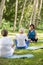 Yoga instructor with seniors outdoors