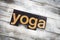 Yoga Letterpress Word on Wooden Background