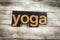 Yoga Letterpress Word on Wooden Background