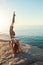 Yoga is like magic. Shot of an athletic young woman practicing yoga on the beach.