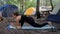 yoga lizard pose utthan pristhasana yoga pose Young woman doing yoga while camping in the forest