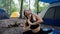 yoga lizard pose utthan pristhasana yoga pose Young woman doing yoga while camping in the forest