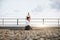 Yoga lover practicing seated asana with twisted arms on roof