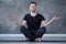 Yoga male beginner practicing yoga sitting in pose and meditates
