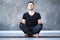 Yoga male beginner practicing yoga sitting in pose and meditates