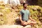 Yoga master on stones sitting in lotus pose