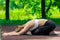 Yoga on a mat in the park, portrait of an active trainer