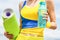 Yoga mat and water bottle. Healthy lifestyle concept. Closeup. Fitness girl with yoga mat over sky background. Woman in