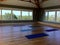 Yoga mats in a studio classroom with wood floors