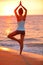 Yoga meditation woman meditating at beach sunset