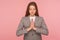 Yoga and mind control. Portrait of young woman in business suit meditating with prayer hand gesture