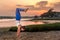 Yoga Model Doing a Handstand On Beach at Sunset