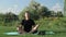 Yoga in morning. Man practices yoga and meditation in lotus position. Male sitting on fitness mat and doing meditation practice in