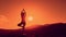 Yoga in mountains at sunset, meditating woman pulls her hands to the sun, tree pose