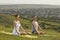 Yoga in nature. Millennial couple doing yoga meditation in mountains. Man and woman practicing breath exercises outdoors