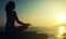 Yoga outdoors. silhouette of a woman sitting in a lotus position