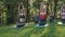 Yoga at park, group of mixed age women doing pose while sunset. slow motion