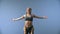 Yoga, portrait of happy girl with pigtails is balancing on legs of her male partner on background of sky outdoors