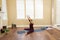 Yoga Pose Upavista Konasana seated indoors