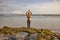 Yoga pose. Woman practicing yoga at the beach. Young woman standing and raising arms with namaste mudra. Bali