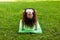 Yoga practice in summer park, muscle stretching. Pretty woman leads healthy lifestyle