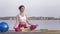 Yoga relaxing, young attractive yogi girl in lotus position meditates and delight spiritual calmnes on nature