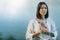 Yoga Retreat. Peaceful Young Woman Sitting in Lotus Position and Meditating by the Lake