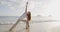 Yoga retreat and training - woman in yoga pose at beach