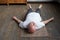 Yoga. Senior man meditating on a wooden floor and lying in Shavasana pose.
