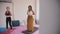 Yoga session - three women do yoga in the studio in daylight