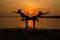 YOGA Silhouette two woman practicing yoga poses on sunset rivers