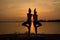YOGA Silhouette two woman practicing yoga poses on sunset rivers