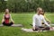 Yoga sportsmen in park - athletes in lotus pose