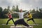 Yoga sportsmen in park - performs exercise outdoors outdoor at morning