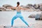 Yoga, stretching and back view of woman at the beach for workout or training as health, mindfulness and wellness routine