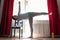 Yoga student standing in ardha chandrasana or Half Moon Pose leaning on chair