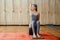 Yoga studio. Woman stretching isitting with feet on Sadhu board. Yoga, sport and health concept