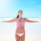 Yoga synchronizes the mind, body and soul. a young woman doing yoga at the beach.