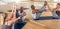 Yoga teacher helps couples learn yoga poses