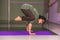 Yoga teacher showing yoga asana in fitness class