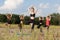 yoga teacher and students practicing yoga outdoors