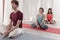 Yoga teachers sitting in the lotus position with their eyes closed.